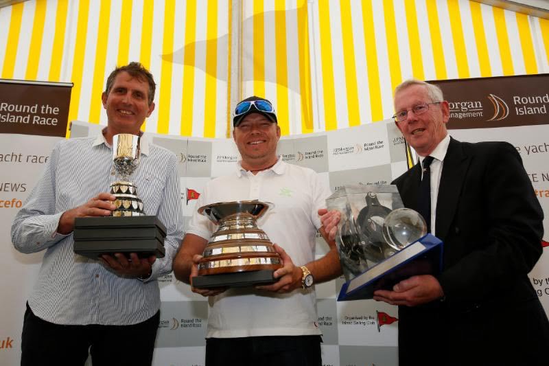 Lloyd Thornburg (centre) and his co-helm Brian Thompson (left) are pictured with Rear Commodore Peter Bingham and their fantastic collection of trophies after their stunning & record-breaking Race on Phaedo^3. Image: Patrick Eden.