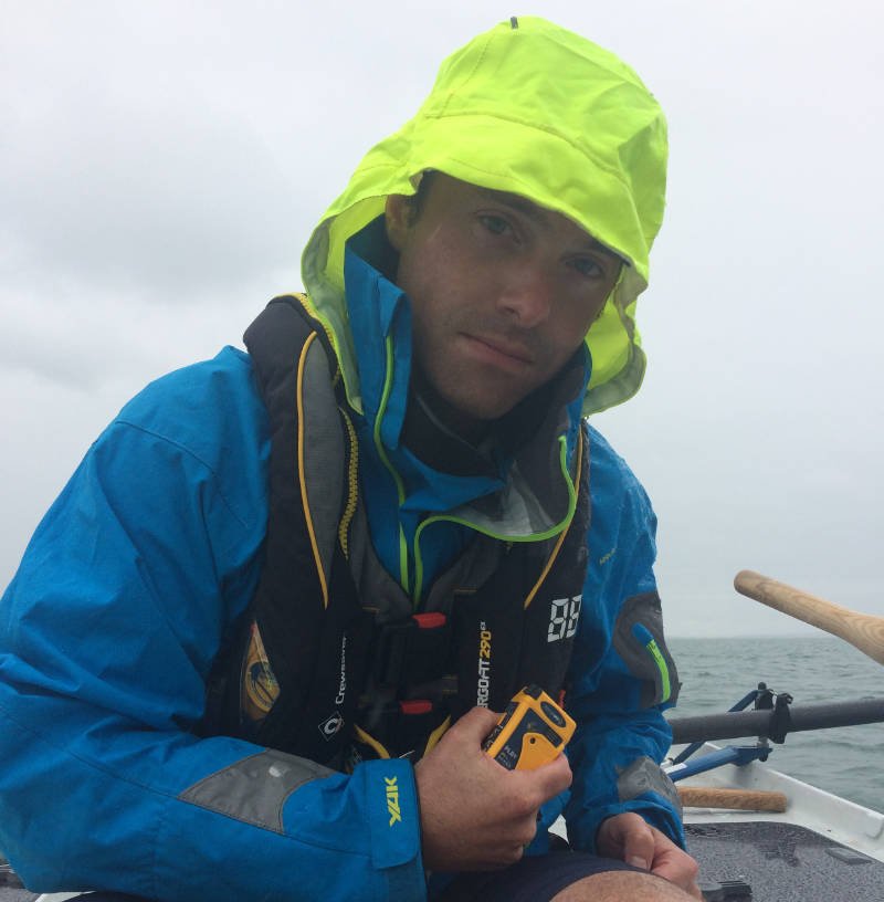 Carbon Zerow rower Kyle Smith with one of the Ocean Signal rescueME PLB1s